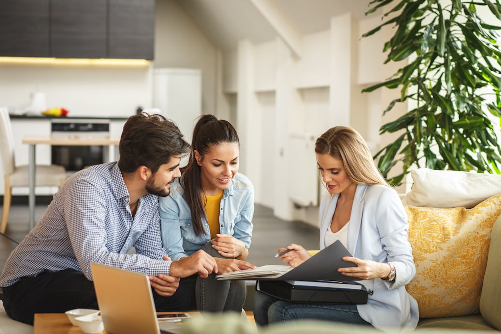 homeowners going over paperwork with insurance agent