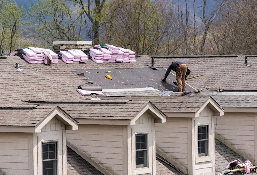 how often to replace roof-technician on a roof laying shingles and insulation