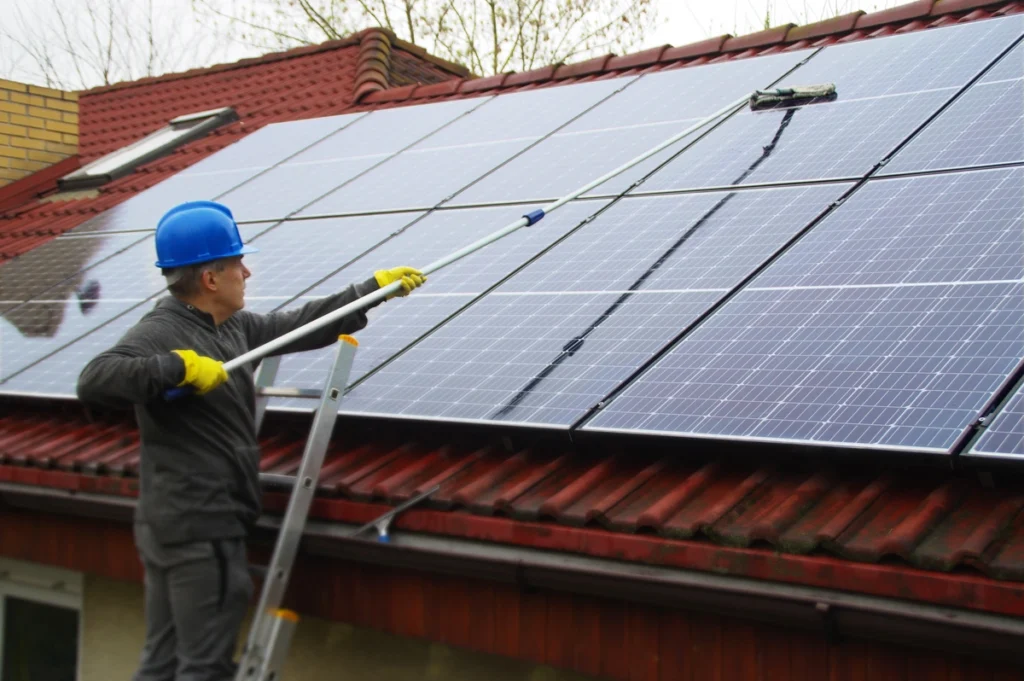 tech cleaning roof solar panels