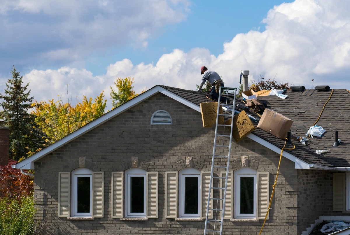 technician repairing roof