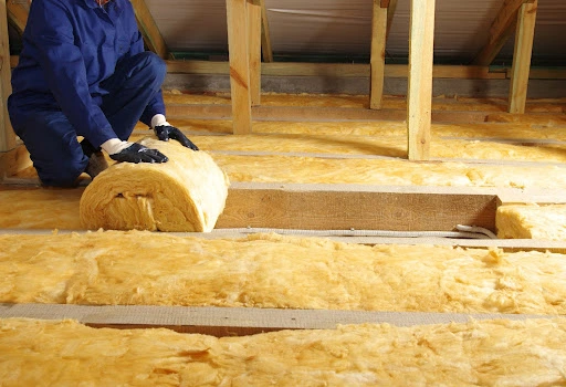 roof-insulation-technician-rolling-insulation