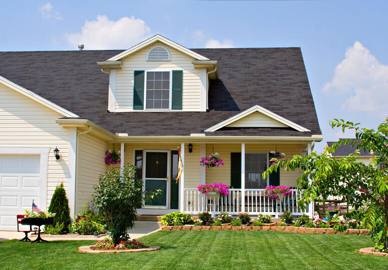 roofing clermont-pale yellow sided house with dark gray roofing