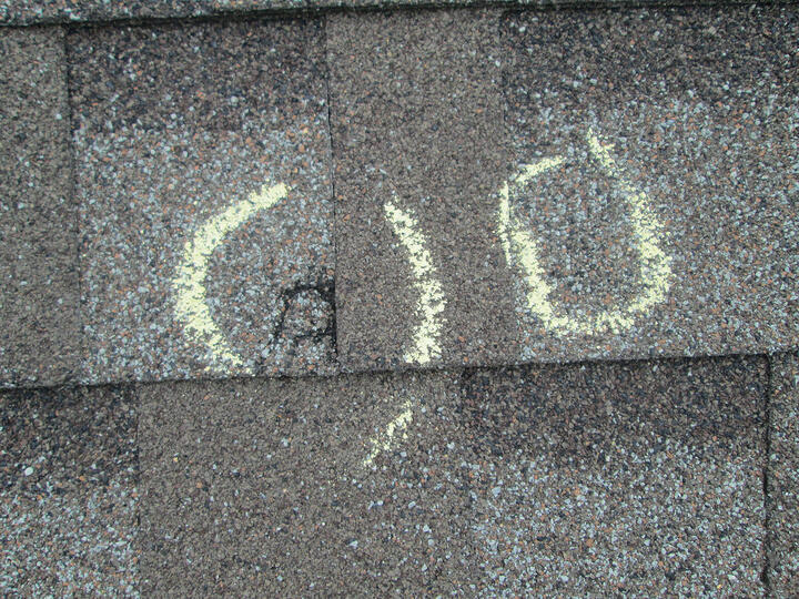 storm damage roof inspection-hail damage marked in chalk on a roof